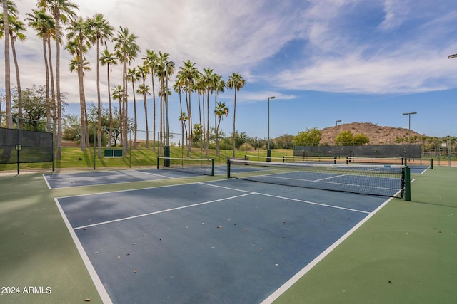 view of tennis court with fence