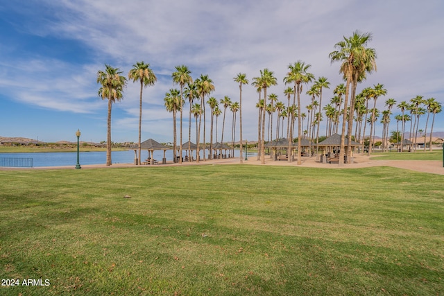 view of home's community featuring a water view and a yard