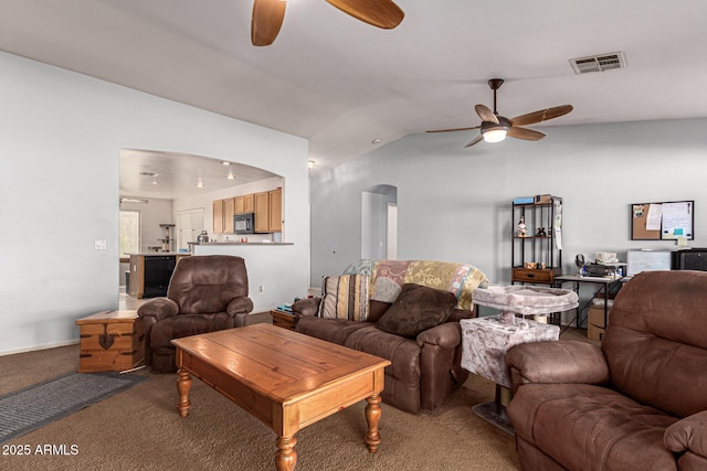 living room featuring carpet floors, vaulted ceiling, and ceiling fan