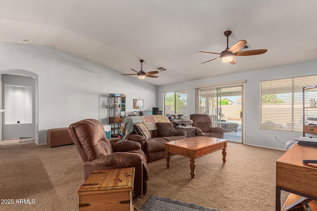 carpeted living room with ceiling fan and vaulted ceiling