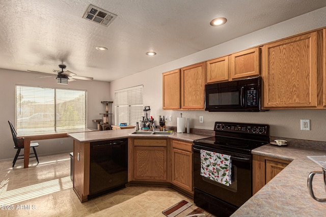 kitchen featuring kitchen peninsula, ceiling fan, a textured ceiling, black appliances, and sink