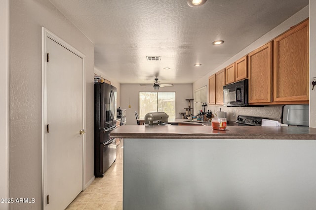 kitchen with ceiling fan, sink, kitchen peninsula, and black appliances