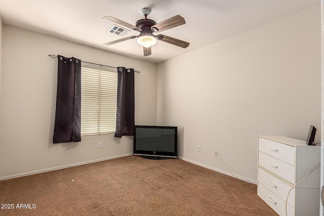 unfurnished room with ceiling fan and carpet