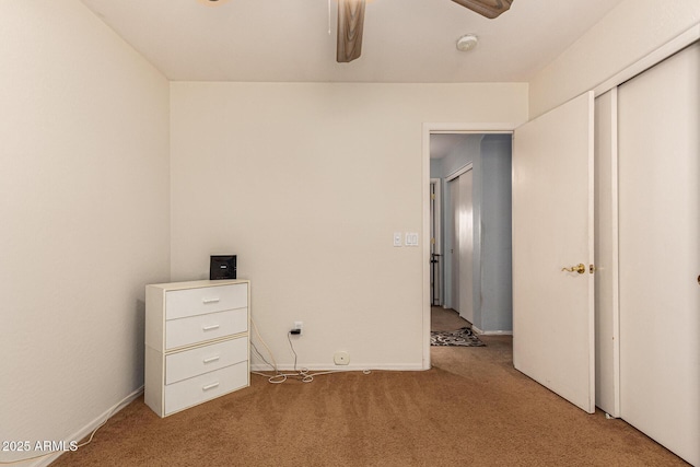 unfurnished bedroom with carpet floors, a closet, and ceiling fan