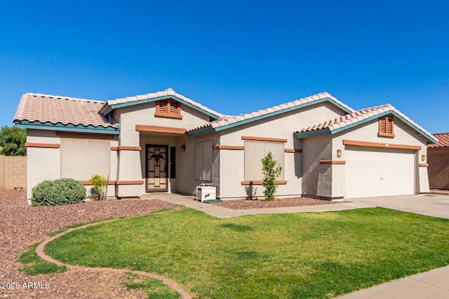 mediterranean / spanish-style house featuring a garage and a front yard