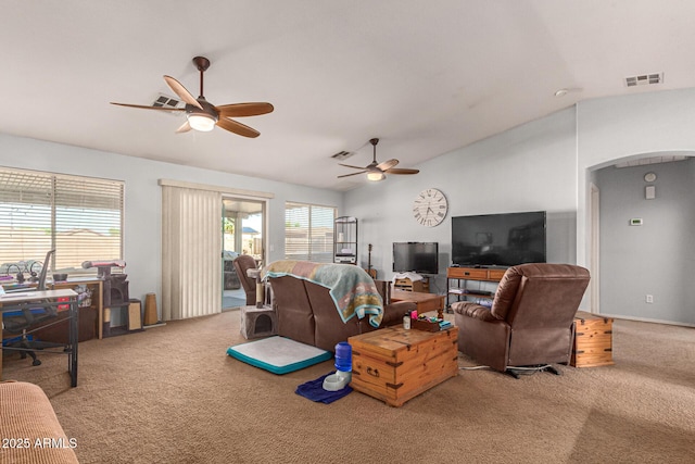 carpeted living room with ceiling fan and vaulted ceiling