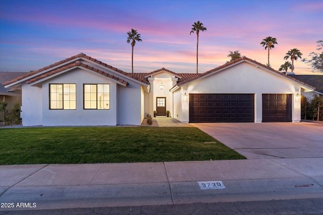 view of front facade with a garage and a yard