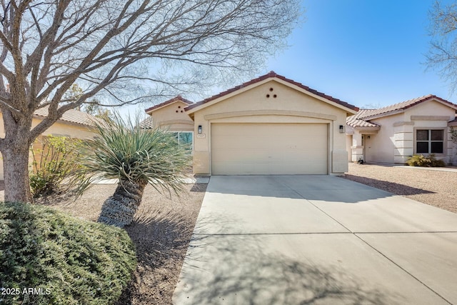 mediterranean / spanish-style home with a garage, driveway, a tile roof, and stucco siding