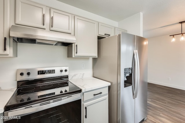 kitchen featuring light wood-style flooring, stainless steel appliances, hanging light fixtures, range hood, and light stone countertops