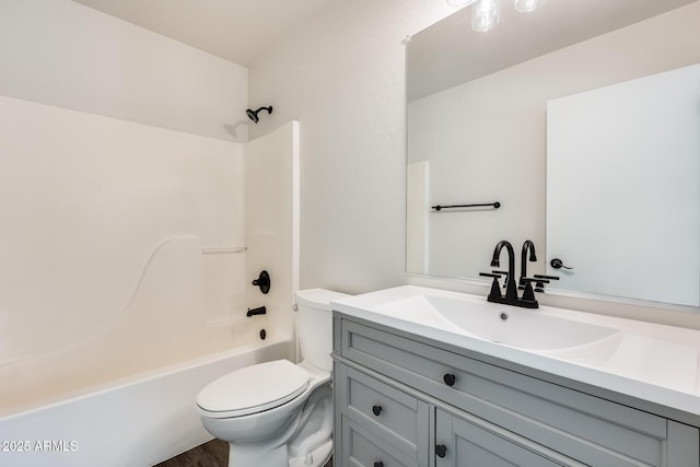 bathroom with toilet, shower / bathtub combination, and vanity