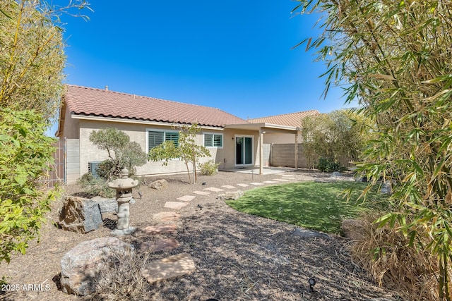 back of property with a patio, fence, a tiled roof, and stucco siding