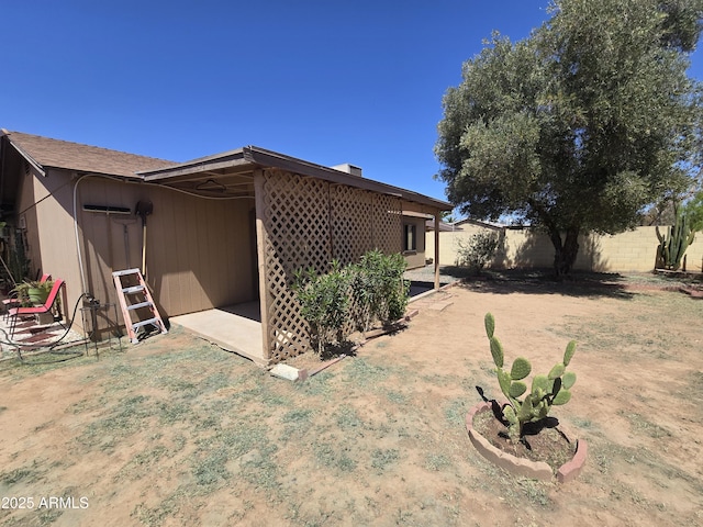 back of house featuring fence