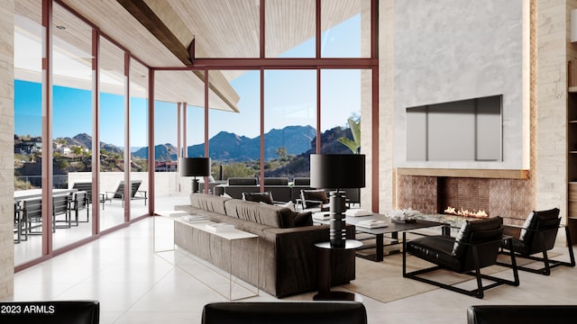 tiled living room featuring a towering ceiling, expansive windows, and a mountain view