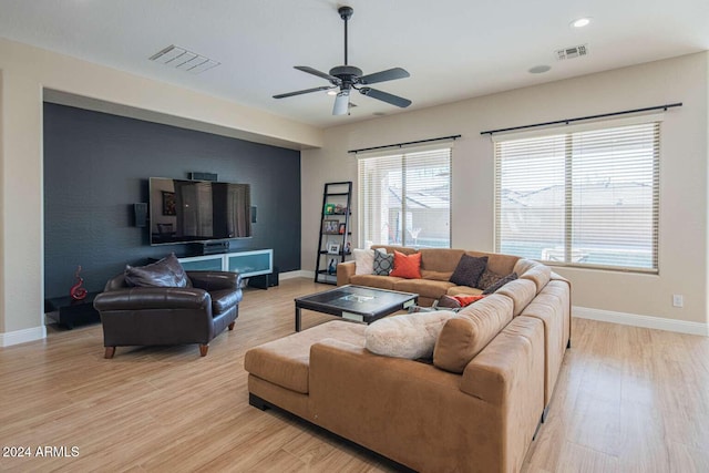 living room featuring light hardwood / wood-style floors and ceiling fan