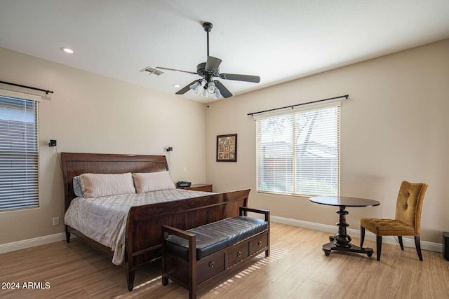 bedroom with light hardwood / wood-style floors and ceiling fan