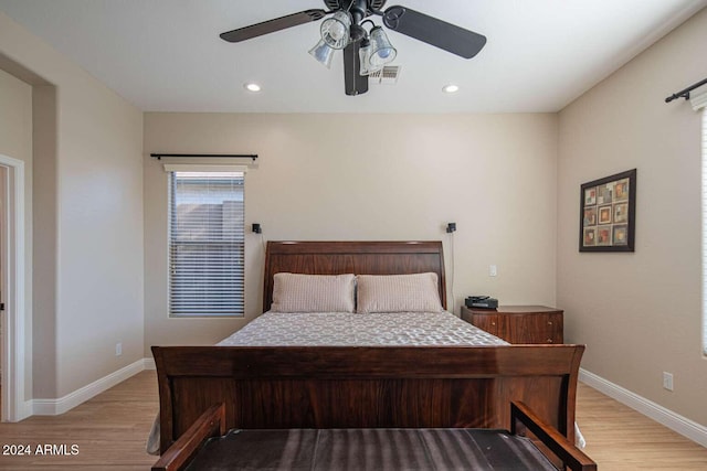 bedroom with light hardwood / wood-style floors and ceiling fan