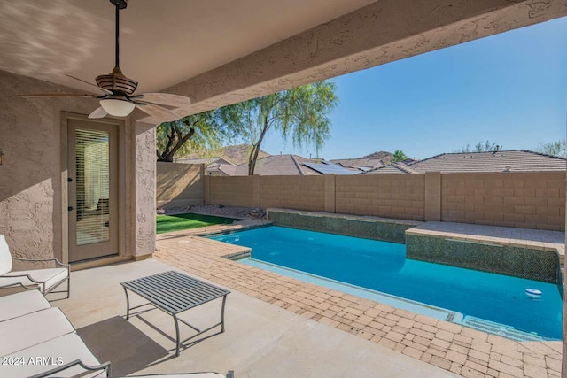 view of swimming pool with a patio area and ceiling fan