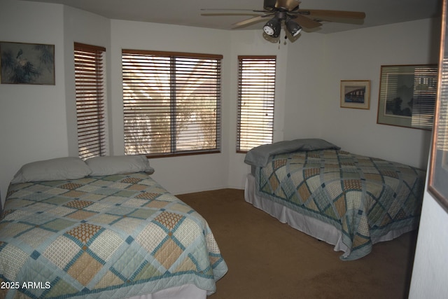 carpeted bedroom featuring multiple windows and ceiling fan