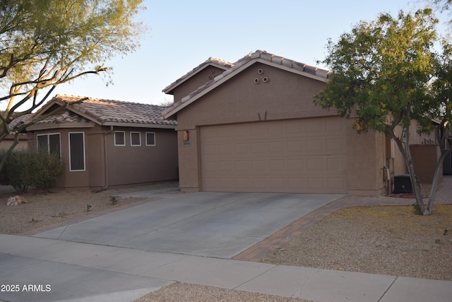 view of front of home featuring a garage and central AC