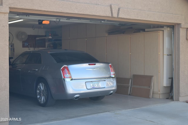 garage with a garage door opener and electric panel