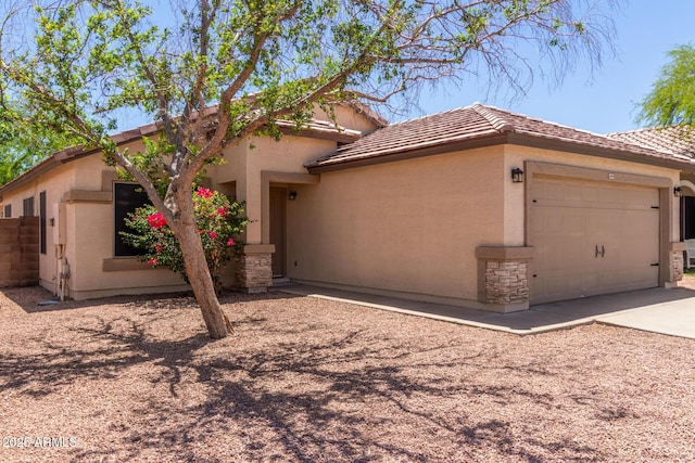 14919 W Hearn Cir, Surprise, AZ 85379 - view of front of house with a tile roof, a garage, concrete driveway, stucco siding, and fence