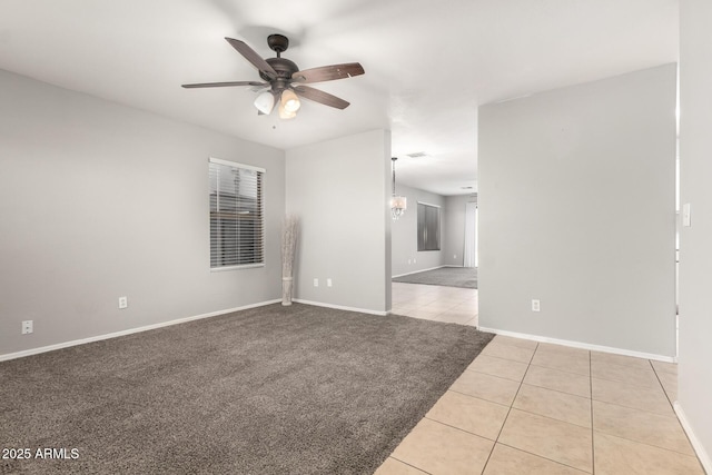 14919 W Hearn Cir, Surprise, AZ 85379 - carpeted empty room featuring tile patterned flooring, ceiling fan, and baseboards