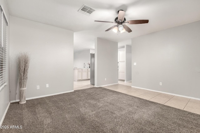 14919 W Hearn Cir, Surprise, AZ 85379 - unfurnished room with a ceiling fan, light carpet, light tile patterned flooring, and baseboards