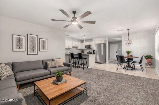 14919 W Hearn Cir, Surprise, AZ 85379 - living area featuring a chandelier, a ceiling fan, and light tile patterned floors