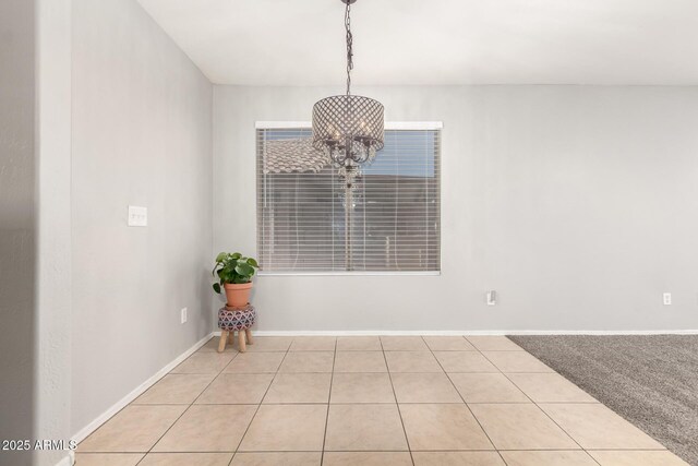14919 W Hearn Cir, Surprise, AZ 85379 - unfurnished dining area featuring tile patterned floors, a chandelier, and baseboards