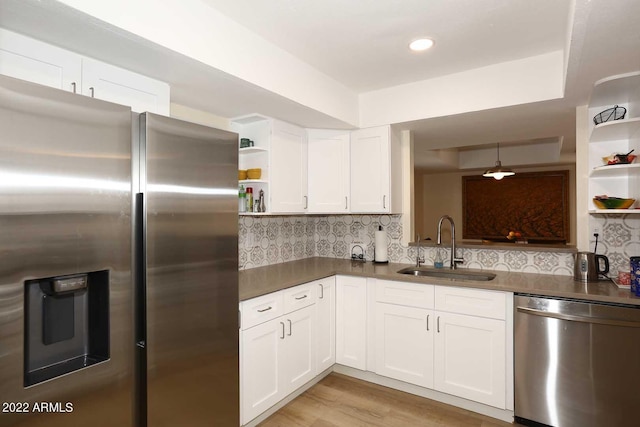 kitchen featuring light wood-type flooring, white cabinetry, sink, and appliances with stainless steel finishes