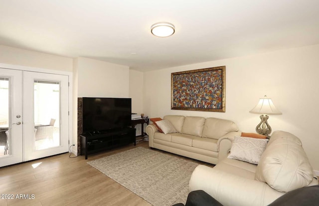 living room featuring french doors and light hardwood / wood-style floors