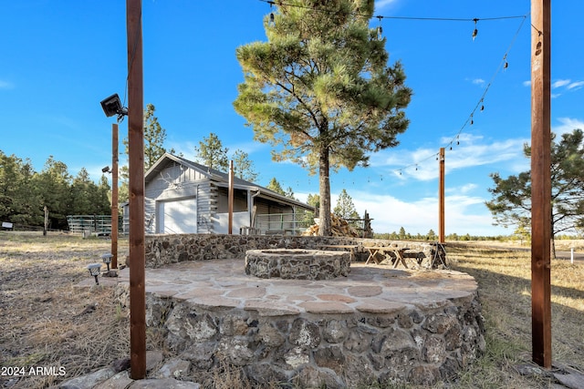 exterior space featuring a fire pit and a garage