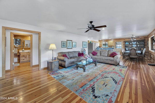 living room with hardwood / wood-style floors and ceiling fan