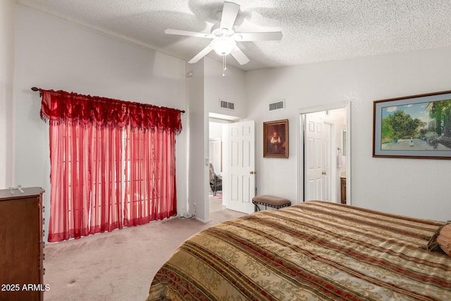 carpeted bedroom with ceiling fan, a textured ceiling, lofted ceiling, and connected bathroom