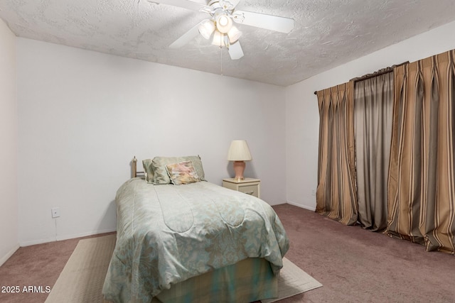 bedroom with ceiling fan, carpet floors, and a textured ceiling