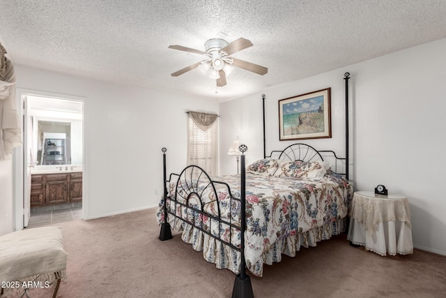 carpeted bedroom with ceiling fan, sink, connected bathroom, and a textured ceiling