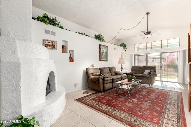 living room featuring a textured ceiling, ceiling fan, light tile patterned floors, and high vaulted ceiling