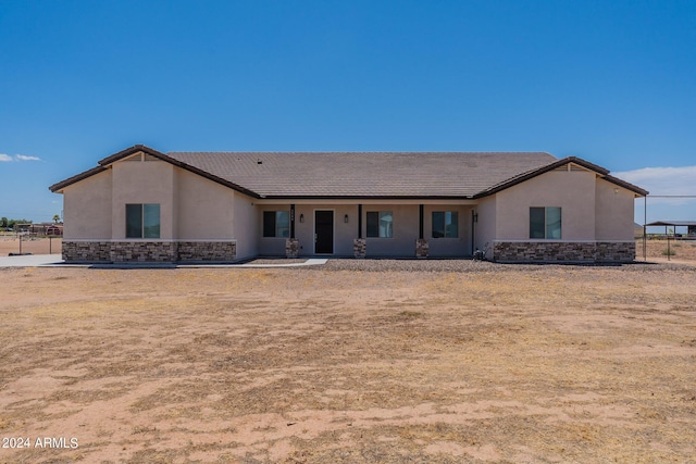 1553 E Kennedy Ave, Coolidge, AZ 85128 - view of front facade with stone siding, fence, a tiled roof, and stucco siding