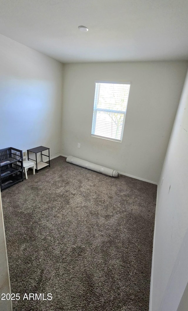 empty room with dark carpet