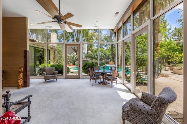 sunroom featuring ceiling fan