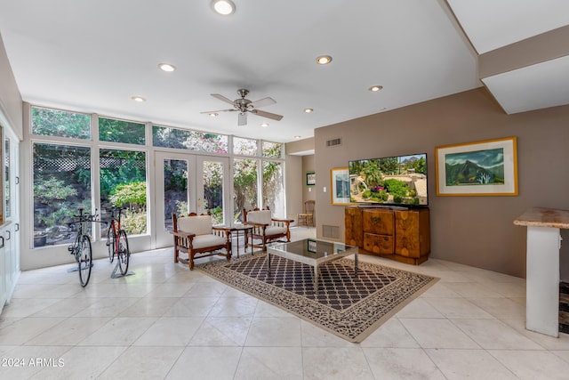 living room with french doors, light tile patterned floors, expansive windows, and ceiling fan