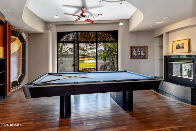 game room featuring wood-type flooring, a textured ceiling, and pool table