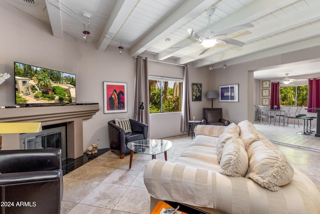 tiled living room with beamed ceiling, ceiling fan, and wood ceiling