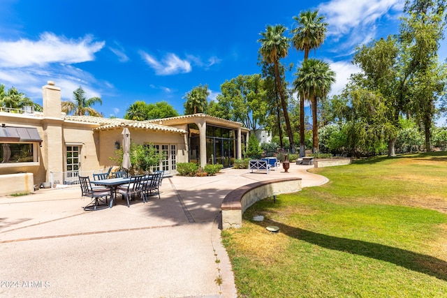 view of community featuring a yard and a patio area