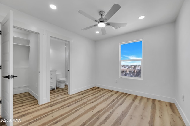 unfurnished bedroom with recessed lighting, baseboards, and ensuite bathroom