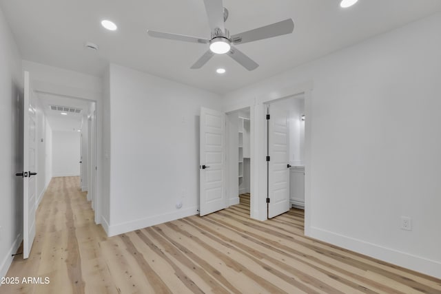 unfurnished bedroom featuring light wood-style flooring, recessed lighting, visible vents, and baseboards
