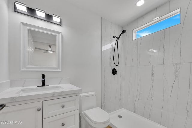 full bath featuring a marble finish shower, toilet, and vanity