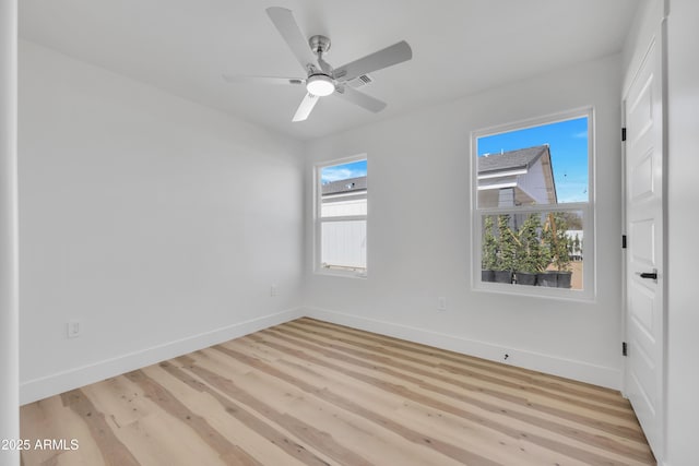 spare room with visible vents, baseboards, light wood-style floors, and ceiling fan
