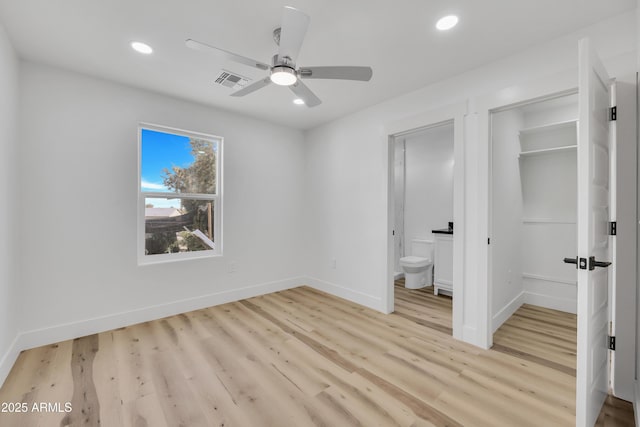 unfurnished bedroom featuring visible vents, baseboards, and light wood-style floors