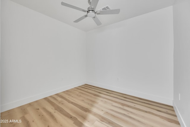 empty room with a ceiling fan, light wood-style floors, and baseboards
